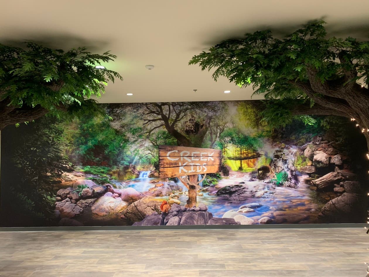 Creek Kids children’s ministry themed environment with monumental sculptural trees